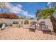 Relaxing backyard featuring a charming fireplace and comfortable lounge chairs at 19347 E Thornton Rd, Queen Creek, AZ 85142