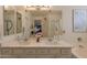 Bathroom with double sinks, marble countertops, a soaking tub, and a glass-enclosed shower at 19347 E Thornton Rd, Queen Creek, AZ 85142