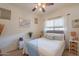 A bright bedroom with carpet, ceiling fan, picture window, and beach-themed decorations at 19347 E Thornton Rd, Queen Creek, AZ 85142