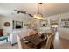 Open-concept living and dining area with wood floors and stylish light fixture at 19347 E Thornton Rd, Queen Creek, AZ 85142