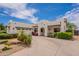 A charming single-story home with desert landscaping, a tile roof, and a wide concrete driveway at 19347 E Thornton Rd, Queen Creek, AZ 85142