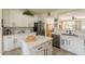 Bright kitchen features stainless steel appliances, an island with marble countertop, and white cabinetry at 19347 E Thornton Rd, Queen Creek, AZ 85142