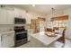 Bright breakfast nook with white cabinets, stainless appliances, and a window with natural light at 19347 E Thornton Rd, Queen Creek, AZ 85142