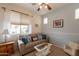 Comfortable living room with a sofa and view of the backyard at 19347 E Thornton Rd, Queen Creek, AZ 85142