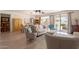 Bright living room features wood floors, a ceiling fan, neutral furniture, and sliding doors to the backyard at 19347 E Thornton Rd, Queen Creek, AZ 85142
