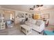 A living room with light wood floors and neutral furniture opens to the dining room and kitchen at 19347 E Thornton Rd, Queen Creek, AZ 85142