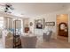 Cozy living room with custom built-in shelving, wood floors, and a ceiling fan at 19347 E Thornton Rd, Queen Creek, AZ 85142