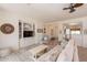 Bright living room features wood floors and a custom built-in shelving unit at 19347 E Thornton Rd, Queen Creek, AZ 85142