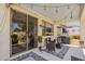 Covered patio featuring wicker furniture, grill, and string lights at 19347 E Thornton Rd, Queen Creek, AZ 85142