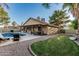 An inviting backyard with a refreshing pool, patio seating, and well-maintained lawn with desert landscaping at 19651 N 34Th St, Phoenix, AZ 85050