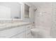 Bright bathroom featuring granite counters, white cabinetry, a shower over tub and modern fixtures at 19651 N 34Th St, Phoenix, AZ 85050