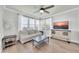 Bright living room with hardwood floors, ceiling fan, and large windows providing natural light at 20100 N 78Th Pl # 3103, Scottsdale, AZ 85255