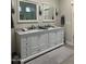 Large primary bath with double sink vanity with granite counters and custom cabinetry at 2013 E Valencia Dr, Phoenix, AZ 85042
