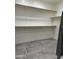 Walk-in closet offering ample storage space with wood racks and contemporary floors at 2013 E Valencia Dr, Phoenix, AZ 85042