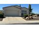 Inviting single-story home featuring a spacious two-car garage and desert-style landscaping at 2013 E Valencia Dr, Phoenix, AZ 85042