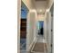 Hallway with neutral paint, carpet runner, and multiple doorways leading to other rooms at 2013 E Valencia Dr, Phoenix, AZ 85042