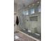 Luxurious glass-enclosed shower with multiple shower heads and built-in seat at 2013 E Valencia Dr, Phoenix, AZ 85042