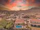Aerial view of a home featuring a pool, covered patio, and desert landscape with mountain views at 209 N 237Th Ave, Buckeye, AZ 85396