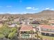 Stunning aerial view showcasing a well-maintained home, pool, and desert landscape with mountains in the distance at 209 N 237Th Ave, Buckeye, AZ 85396