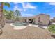 Relaxing backyard with a refreshing pool, covered patio, and low-maintenance landscaping at 209 N 237Th Ave, Buckeye, AZ 85396