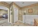 This bathroom features a walk-in shower, a soaking tub, tiled flooring, and access to the Primary bedroom at 209 N 237Th Ave, Buckeye, AZ 85396