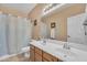 Bright bathroom featuring a double sink vanity, a large mirror, and a shower-tub combo at 209 N 237Th Ave, Buckeye, AZ 85396