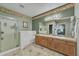 This bathroom features double sinks, a shower, tile flooring, and charming wallpaper accents at 209 N 237Th Ave, Buckeye, AZ 85396