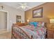 Cozy bedroom with Southwestern decor, wood furniture and a ceiling fan for added comfort at 209 N 237Th Ave, Buckeye, AZ 85396