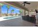 Spacious covered patio overlooking a private pool, perfect for outdoor living and dining at 209 N 237Th Ave, Buckeye, AZ 85396