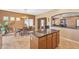 Kitchen island with granite countertops and view of the dining area at 209 N 237Th Ave, Buckeye, AZ 85396