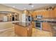 Open kitchen featuring stainless steel appliances, granite countertops and central island at 209 N 237Th Ave, Buckeye, AZ 85396