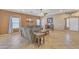 Spacious living room with tile flooring, comfortable seating, a ceiling fan and a wine cabinet at 209 N 237Th Ave, Buckeye, AZ 85396