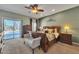 Main bedroom featuring a king-size bed, ceiling fan, dresser, and sliding door access to the backyard pool at 209 N 237Th Ave, Buckeye, AZ 85396