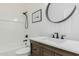 Updated bathroom with a single vanity, white countertop, modern fixtures, and bathtub at 2326 E Spruce Dr, Chandler, AZ 85286