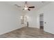 Spacious bedroom with wood-look flooring, ceiling fan, window and access to an ensuite bathroom at 2326 E Spruce Dr, Chandler, AZ 85286