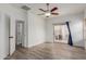 Light-filled bedroom featuring wood-look flooring, ceiling fan, and sliding door to outdoor patio at 2326 E Spruce Dr, Chandler, AZ 85286