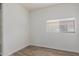 Simple bedroom featuring wood-look flooring, window, and electrical outlets at 2326 E Spruce Dr, Chandler, AZ 85286