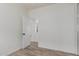 Clean bedroom features wood-look floors, a door, and view to an adjacent room at 2326 E Spruce Dr, Chandler, AZ 85286