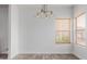 Bright dining area with wood-look tile floors, a modern light fixture, and a window at 2326 E Spruce Dr, Chandler, AZ 85286