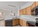 Bright kitchen featuring stainless steel appliances, light wood cabinets and view to the living area at 2326 E Spruce Dr, Chandler, AZ 85286