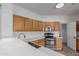 Well-lit kitchen showcases stainless appliances, light wood cabinets, and stylish countertops at 2326 E Spruce Dr, Chandler, AZ 85286
