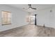 Bright, open-concept living room with wood-look tile floors and a sliding glass door to the backyard at 2326 E Spruce Dr, Chandler, AZ 85286