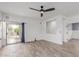 Bright, open-concept living room with wood-look tile floors and a sliding glass door to the backyard at 2326 E Spruce Dr, Chandler, AZ 85286