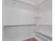 Walk-in closet with ample storage space, shelves, and rods for organization and convenience at 2326 E Spruce Dr, Chandler, AZ 85286
