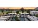 Stunning aerial view of townhomes with a pool and golf course against a vibrant sunset backdrop at 3030 N Hayden Rd # 28, Scottsdale, AZ 85251