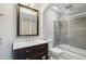 Updated bathroom with a new vanity, framed mirror, and shower over tub at 3030 N Hayden Rd # 28, Scottsdale, AZ 85251