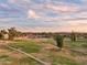 Scenic aerial view of a lush green golf course with winding paths on a partly cloudy day at 3030 N Hayden Rd # 28, Scottsdale, AZ 85251