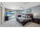 Large main bedroom with a fireplace, a ceiling fan, and a private balcony at 3030 N Hayden Rd # 28, Scottsdale, AZ 85251
