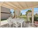 Outdoor dining area with shade covering near a pool and lush landscaping at 3030 N Hayden Rd # 28, Scottsdale, AZ 85251