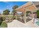 Inviting pool area featuring shaded patio with dining table and manicured landscaping at 3030 N Hayden Rd # 28, Scottsdale, AZ 85251